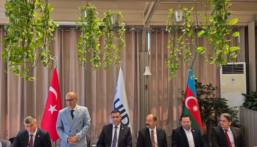 Here's a natural English version of your sentence:  The International Democrat Union brought Azerbaijani journalists together for a breakfast meeting
